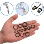 Assorted black rubber O-rings in palm, replacement sealing gaskets for bathroom faucet, shower head and water pipe leak repair