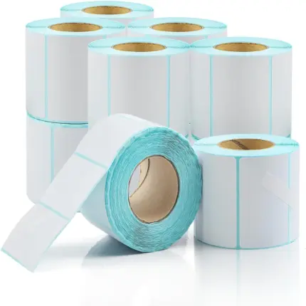 Multiple rolls of white blank self-adhesive thermal labels with light blue edge lining arranged on reflective white background