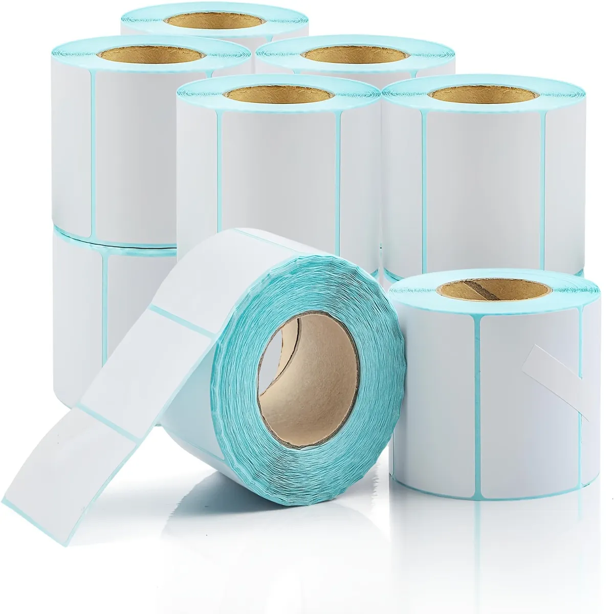 Strong Adhesive Blank Thermal Sticker Labels for Express Logistics & Storage Classification Multiple rolls of white blank self-adhesive thermal labels with light blue edge lining arranged on reflective white background
