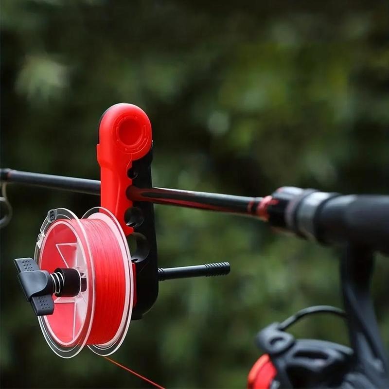 Red and black clamp-style fishing line spooler fixed on a fishing rod, used for quickly winding fishing line during outdoor freshwater and saltwater fishing preparation.