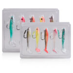 Two transparent storage boxes holding multiple colorful pre-rigged soft plastic swimbaits with sharp hooks, designed for freshwater and saltwater predatory fish angling.