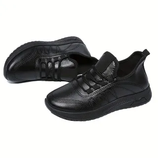Pair of slip-on lace-up black genuine leather women casual sneakers with flexible cushioned sole, designed for long-hour work, walking and daily commuting wear