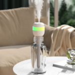 Portable plug-in bottle humidifier with glowing color night light emitting mist, placed on indoor living room table for home dry air moisturizing