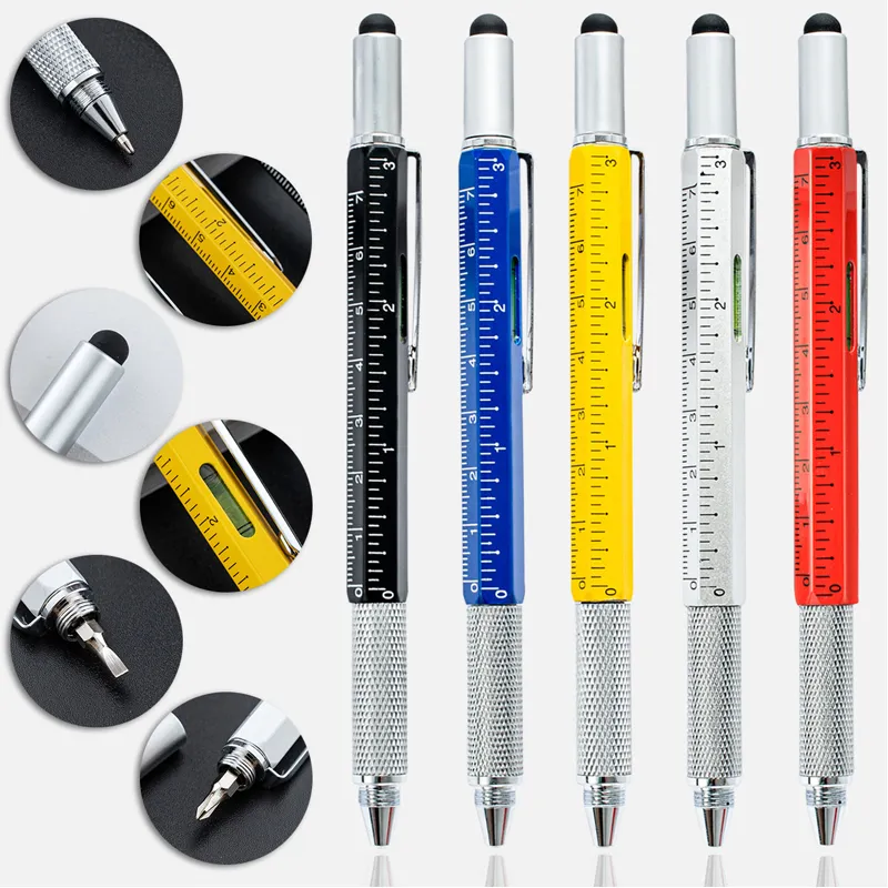 Assorted colored metal multi tool retractable ballpoint pens with printed ruler scale placed on office desk beside laptop for engineering and daily writing use
