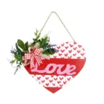 Red and white heart shaped wooden love sign with artificial greenery, plaid bow and jute hanging rope for Valentine front door wall decoration